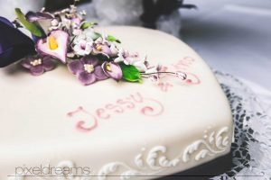 braut und bräutigam schneiden hochzeitstorte bei ihrer hochzeitsfeier