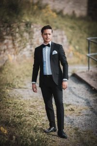Hochzeitsfoto von Bräutigam im Brautkleid, er posiert einem Pfad von Burg Altena